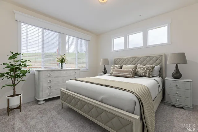 a bedroom with a bed and a potted plant