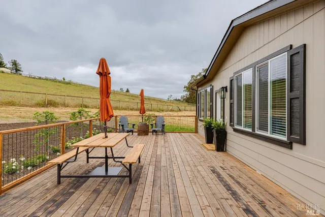 a view of balcony with chairs and wooden floor