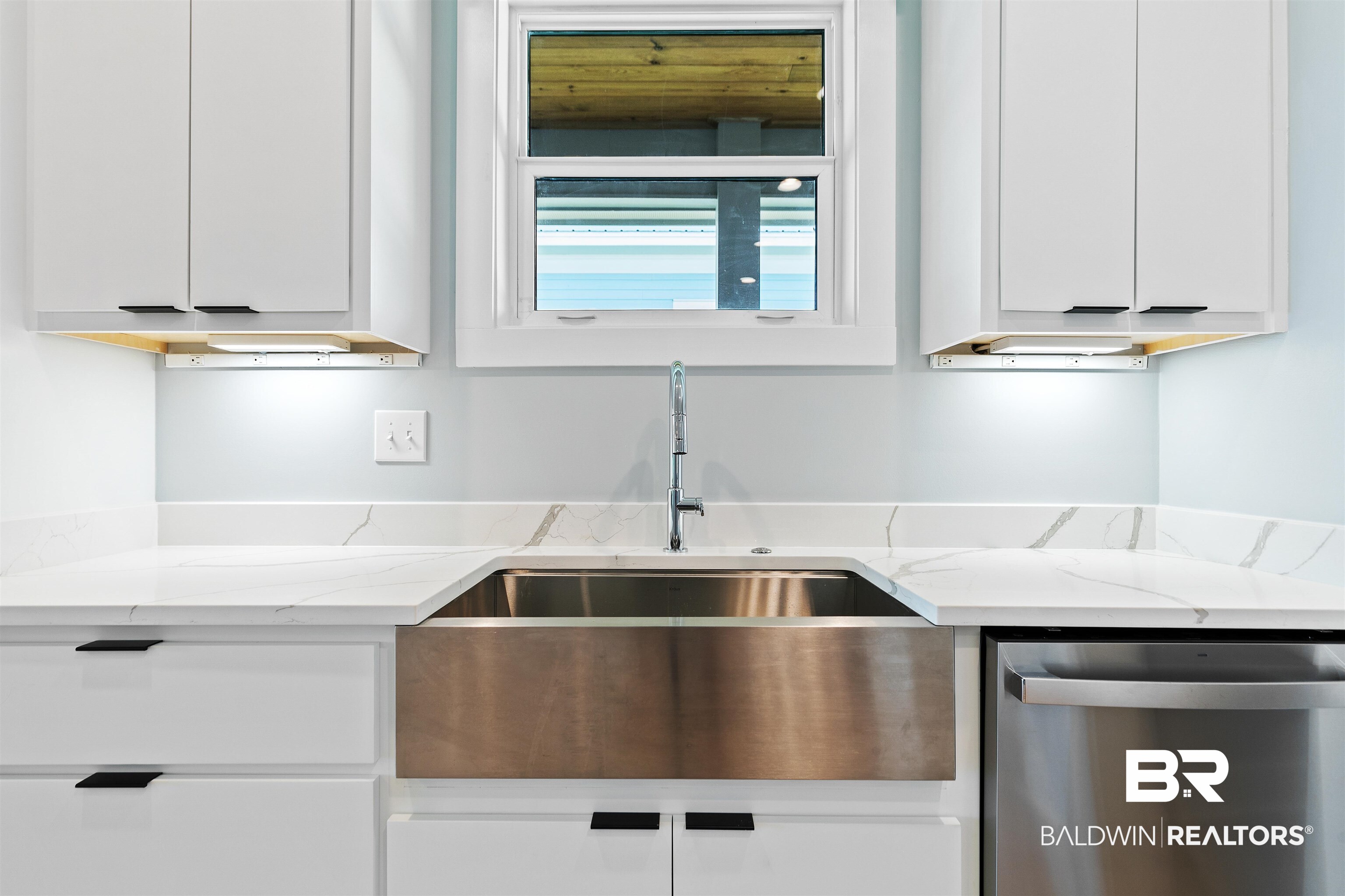 10507 County Road 1 Fairhope, AL 36532 - Photo 14 of 59 Kitchen featuring white cabinetry, light stone countertops, and stainless steel dishwasher