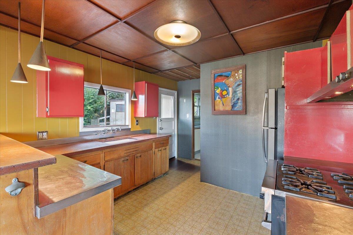 268 Olympian Way Pacifica, CA 94044 - Photo 11 of 23 a kitchen with stainless steel appliances granite countertop a stove a sink and a refrigerator