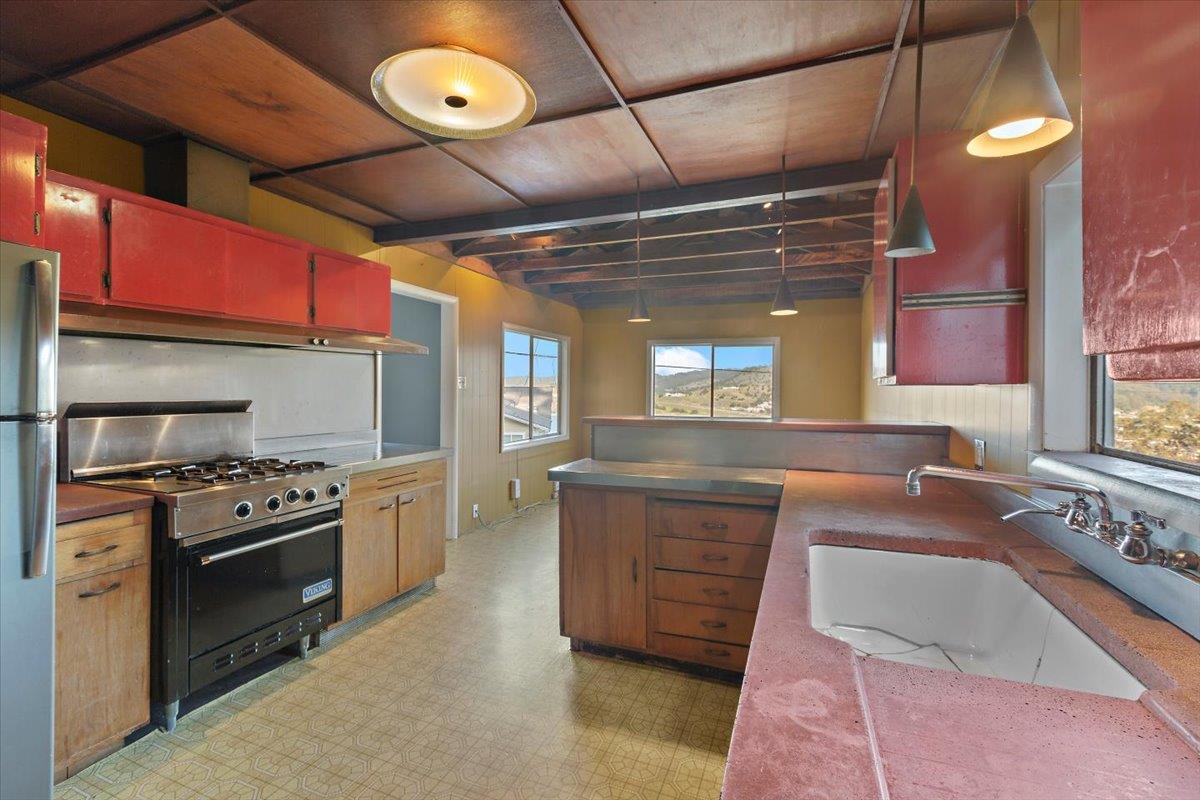 268 Olympian Way Pacifica, CA 94044 - Photo 12 of 23 a kitchen with stainless steel appliances granite countertop a stove a sink and a microwave