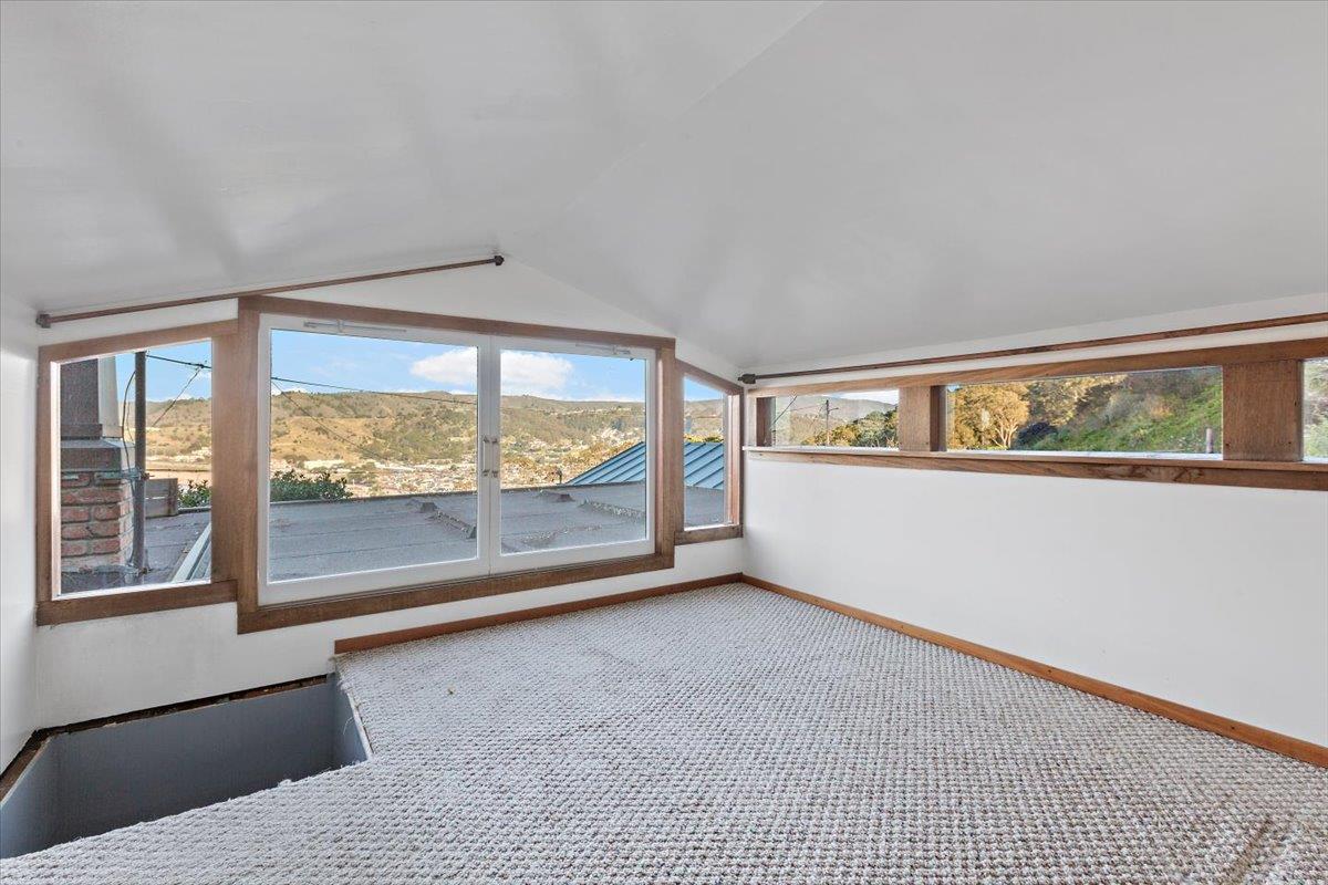 268 Olympian Way Pacifica, CA 94044 - Photo 16 of 23 an empty room with wooden floor and windows