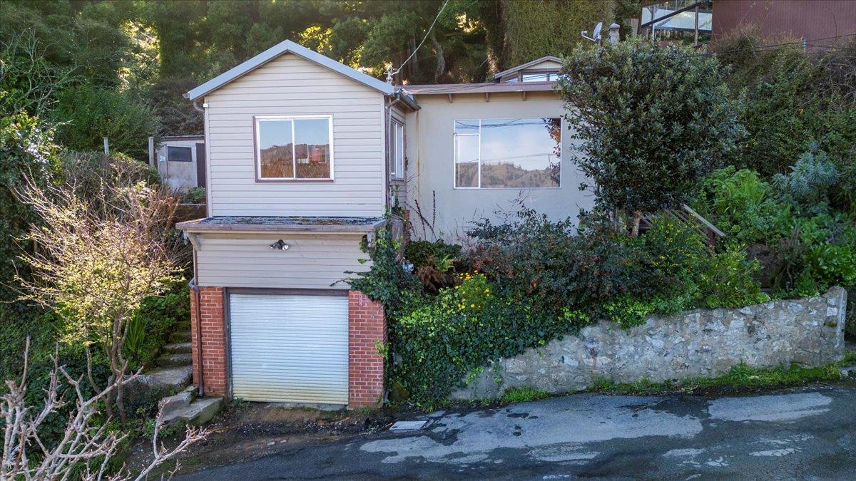268 Olympian Way Pacifica, CA 94044 - Photo 3 of 23 a front view of a house with a yard and garage