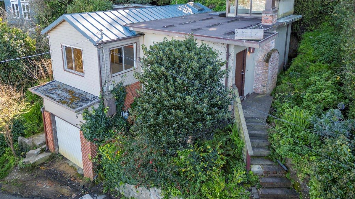 268 Olympian Way Pacifica, CA 94044 - Photo 4 of 23 a aerial view of a house with plants and trees