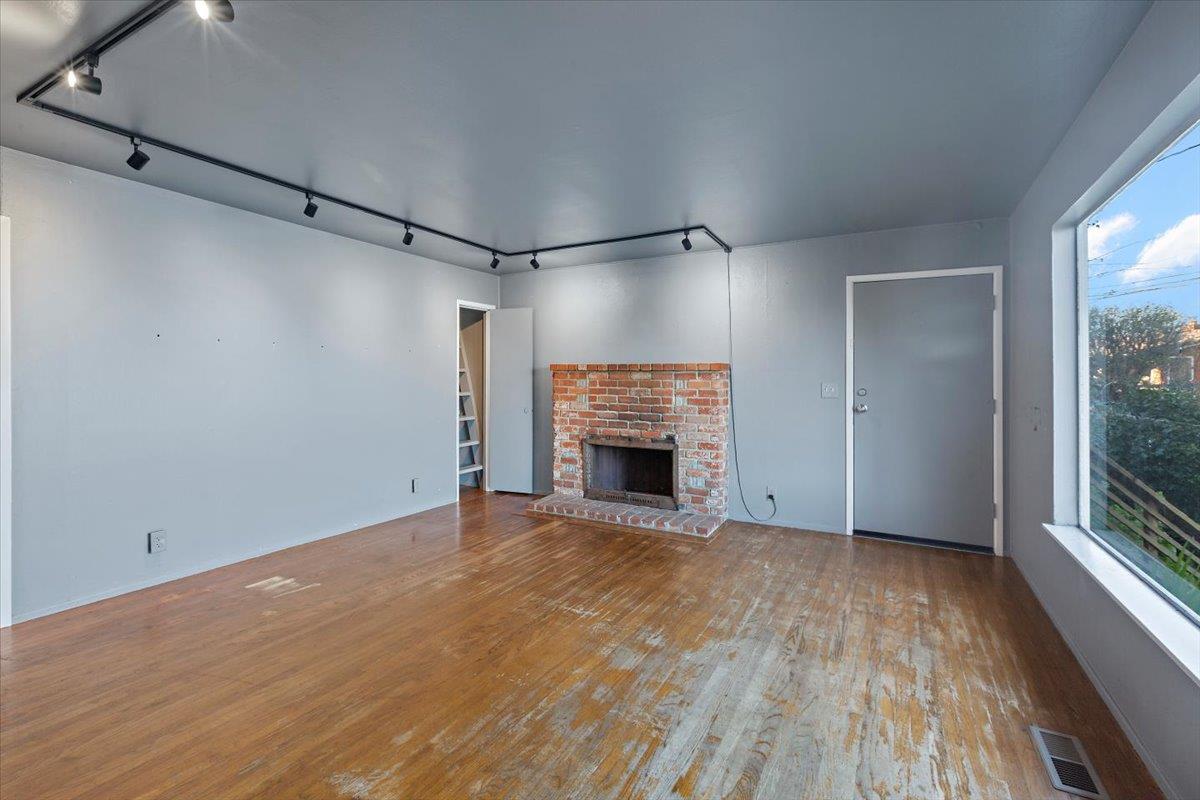 268 Olympian Way Pacifica, CA 94044 - Photo 7 of 23 a view of an empty room with a fireplace and a window