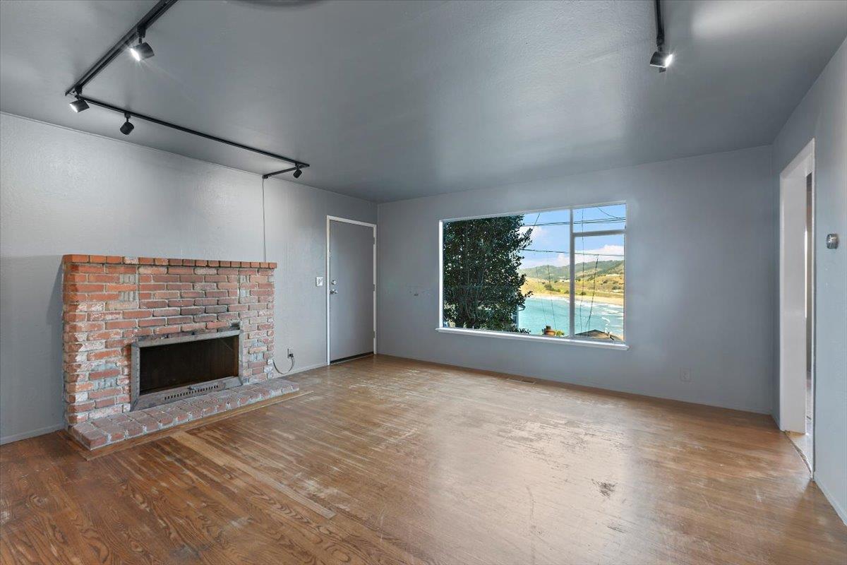 268 Olympian Way Pacifica, CA 94044 - Photo 8 of 23 an empty room with windows and fireplace