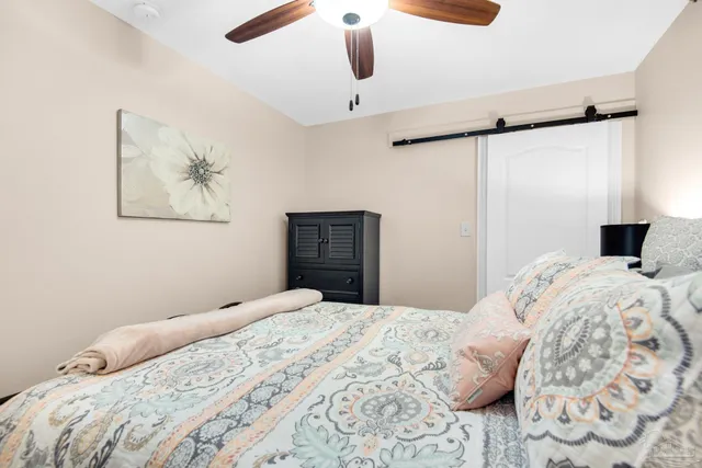 a bedroom with a large bed and a window