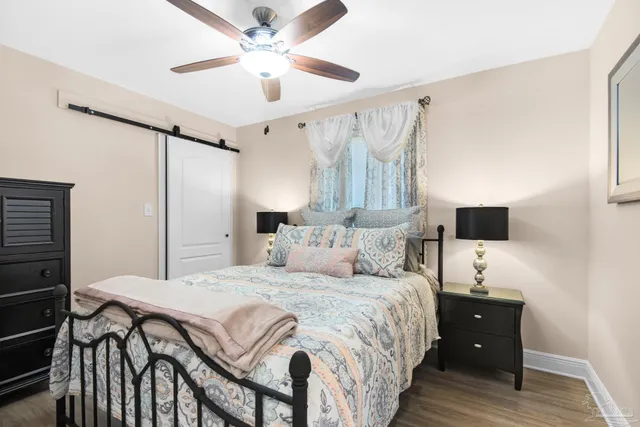a bedroom with a bed and a flat tv screen on the dresser