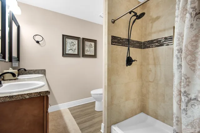 a bathroom with a sink toilet and shower