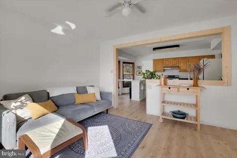 a living room with furniture and a mirror