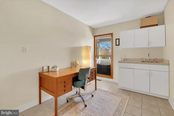 a kitchen with a dining table chairs and cabinets