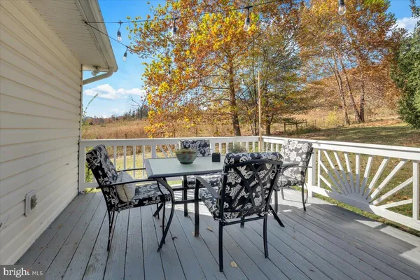 a view of a chairs and table on the deck