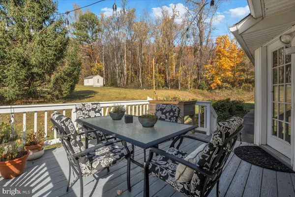 a view of balcony with wooden floor and outdoor seating