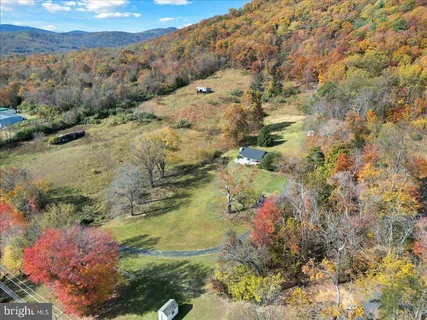 a view of mountains and covered with trees