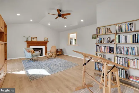 a living room with furniture and a book shelf