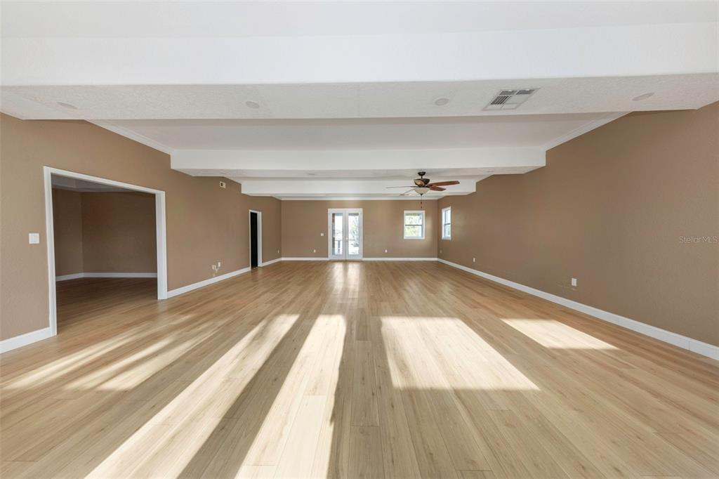 20138 Bowman Road Spring Hill, FL 34610 - Photo 18 of 40 a view of empty room with wooden floor