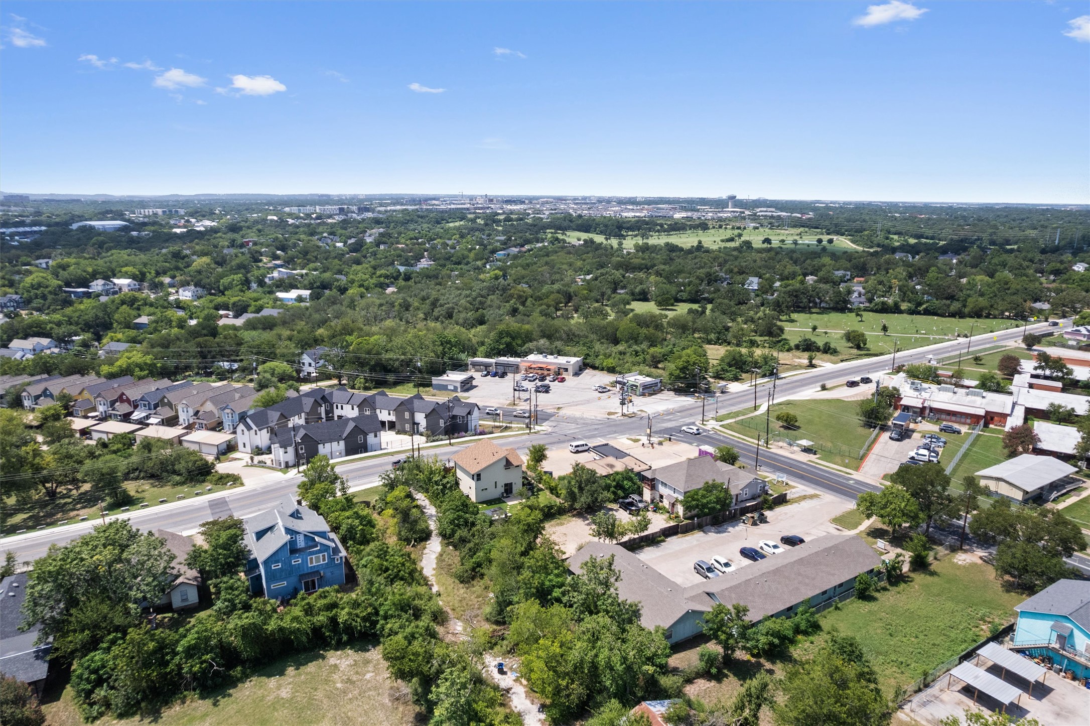 1147 Webberville Road Austin, TX 78721 - Photo 35 of 37 An aerial perspective reveals a vibrant neighborhood nestled among lush greenery, with varied residential and commercial properties.