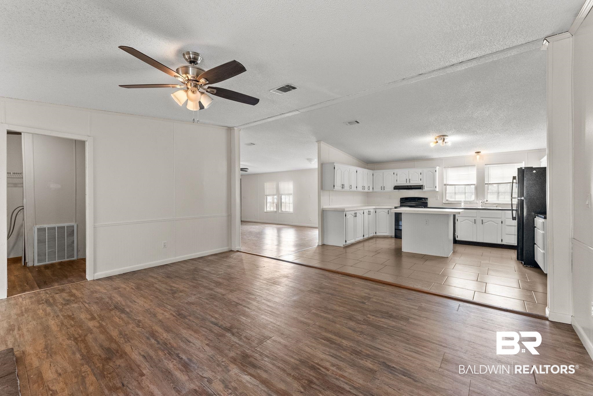 34904 Pine Road South Stapleton, AL 36578 - Photo 10 of 42 Unfurnished living room with dark wood-type flooring and ceiling fan