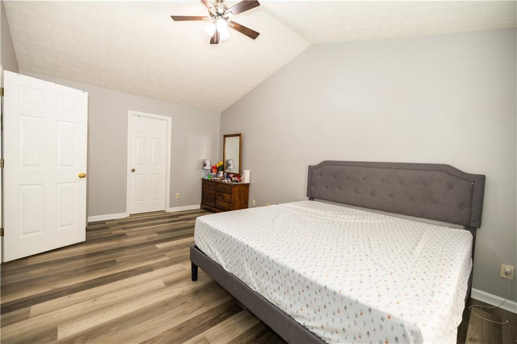 599 Rivulett Court Lawrenceville, GA 30043 - Photo 12 of 31 a spacious bedroom with a bed and cabinet