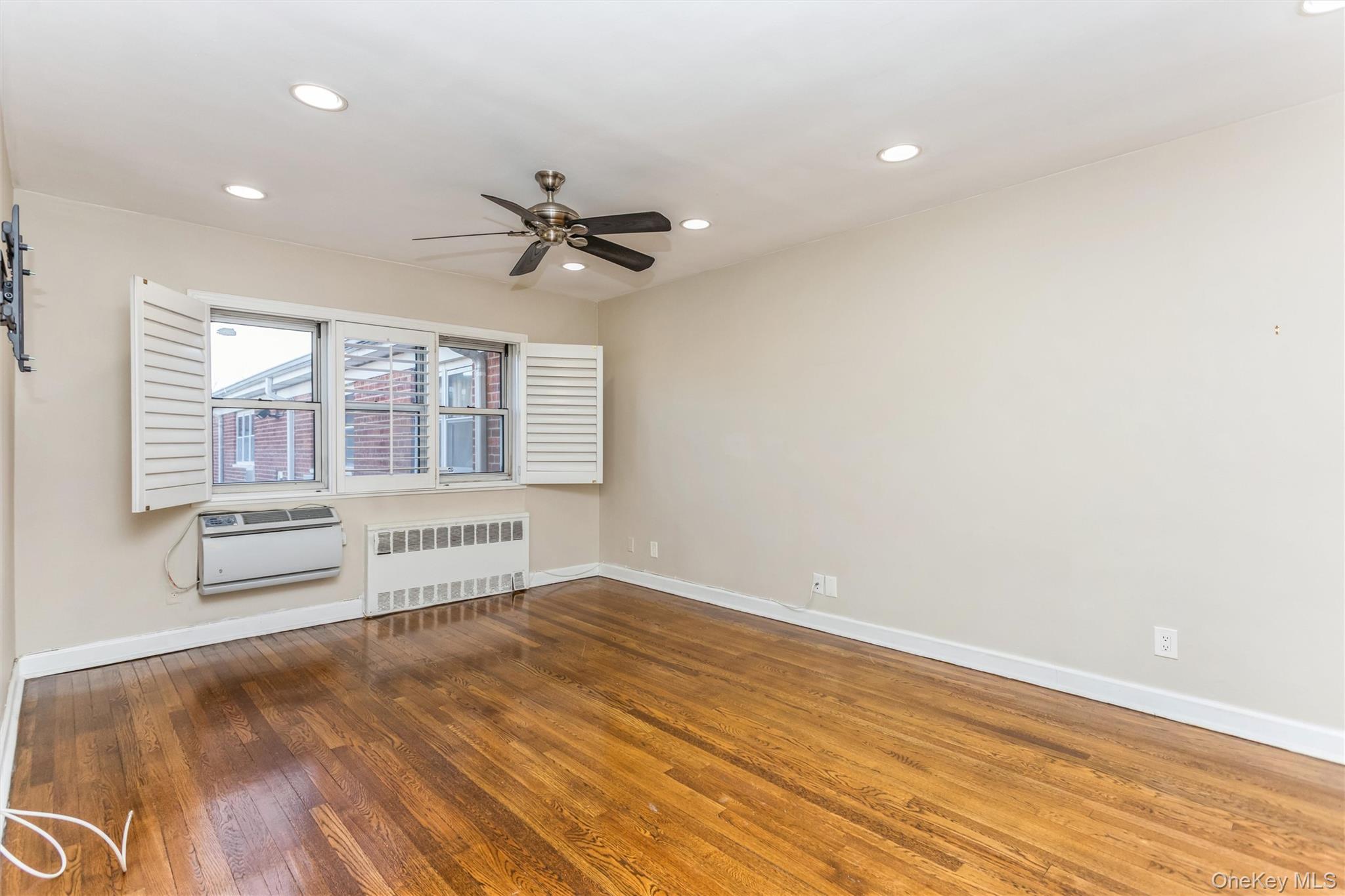 wooden floor in an empty room with a window