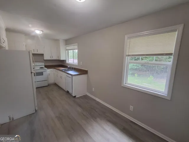 a kitchen with a refrigerator and a stove top oven