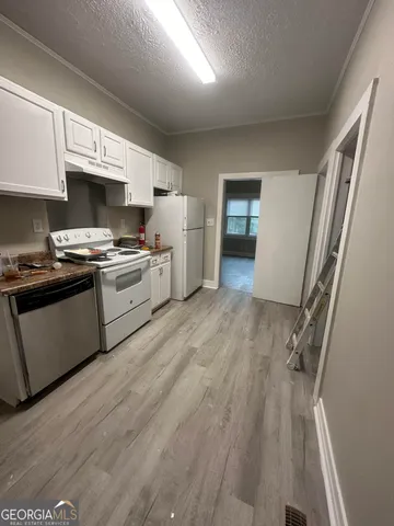 a kitchen with a stove a sink and a refrigerator