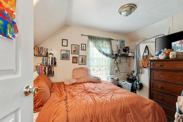 a bed room with a bed and a tv