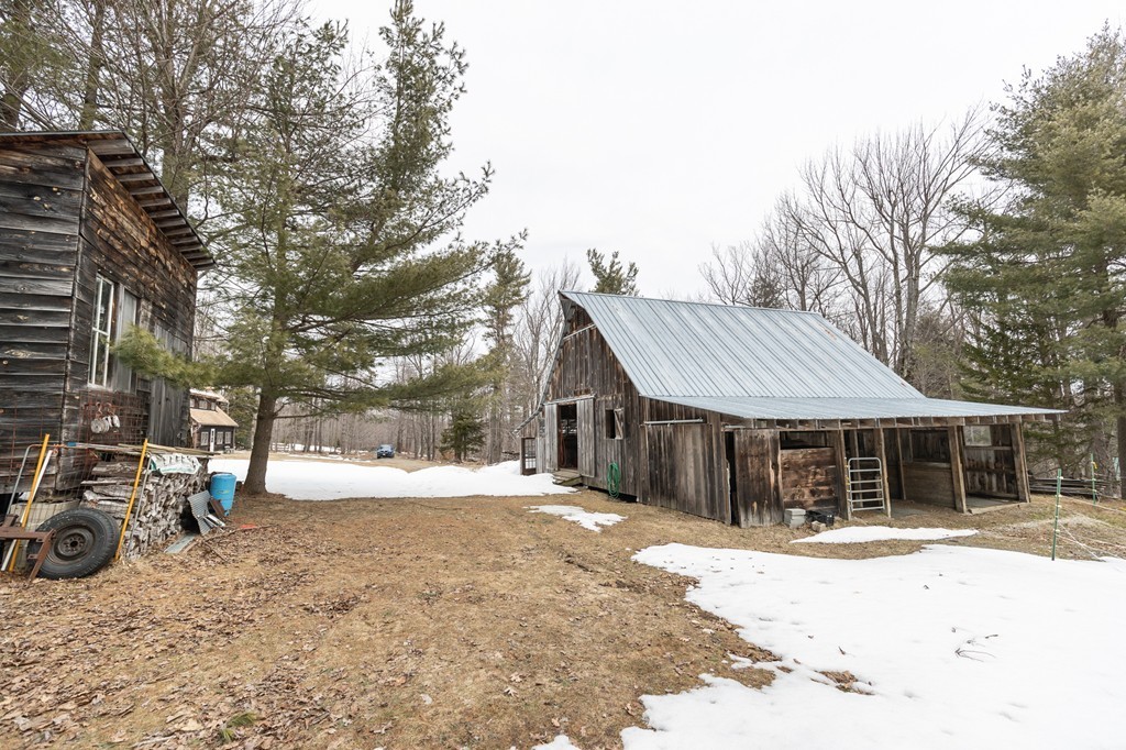 235 Bug Hill Road Ashfield, MA 01330 - Photo 25 of 30 a front view of a house with a yard and a garage