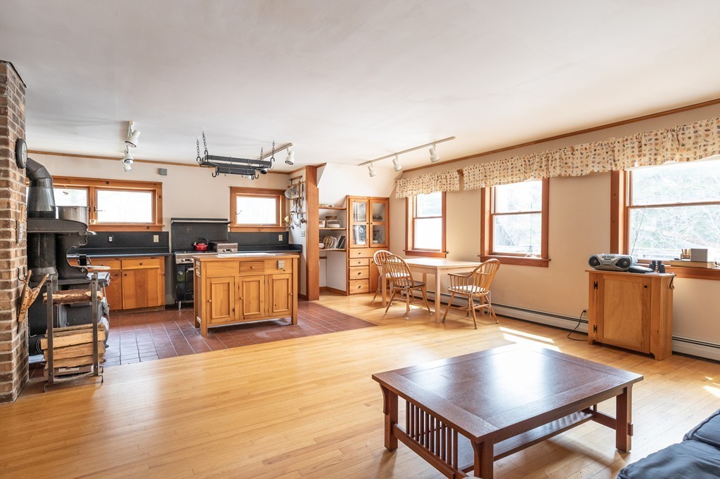 235 Bug Hill Road Ashfield, MA 01330 - Photo 6 of 30 a living room with stainless steel appliances kitchen island granite countertop a stove and a view of living room