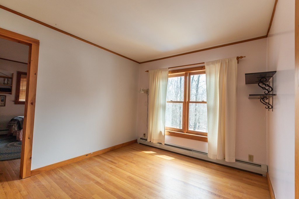 235 Bug Hill Road Ashfield, MA 01330 - Photo 10 of 30 an empty room with wooden floor and windows