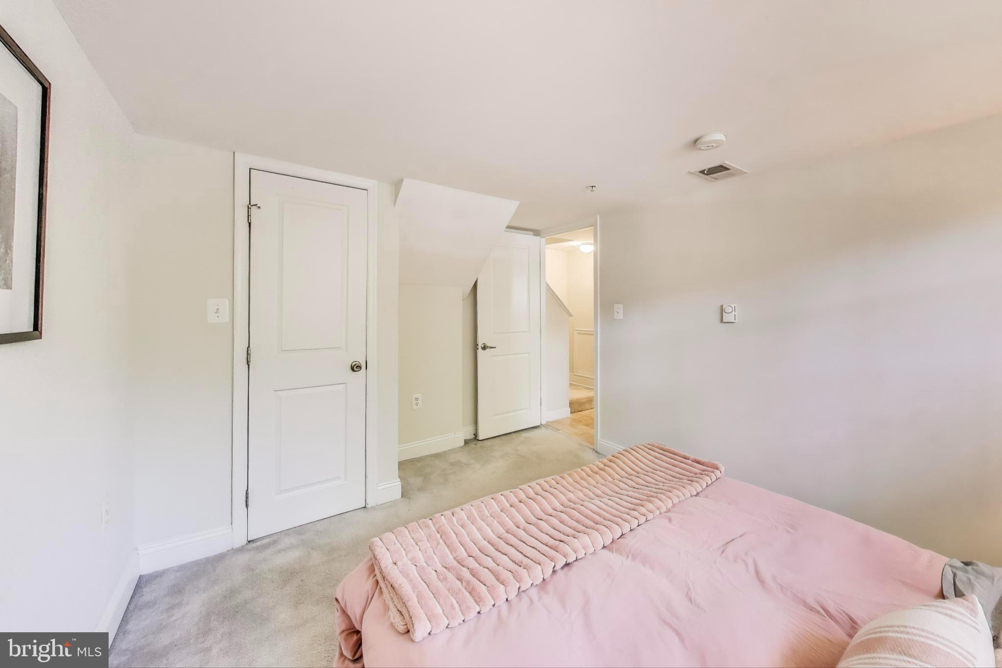 1106 Columbia Road Northwest, Unit 103 Washington, DC 20009 - Photo 13 of 21 a bedroom with a bed and a closet