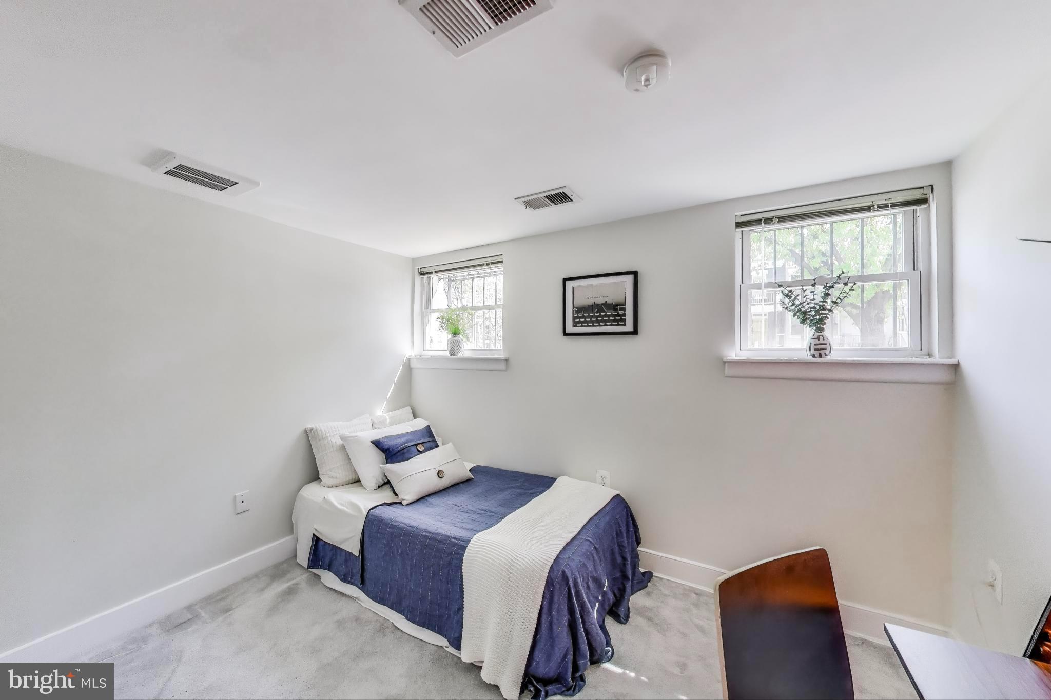 1106 Columbia Road Northwest, Unit 103 Washington, DC 20009 - Photo 14 of 21 a room with furniture and a window