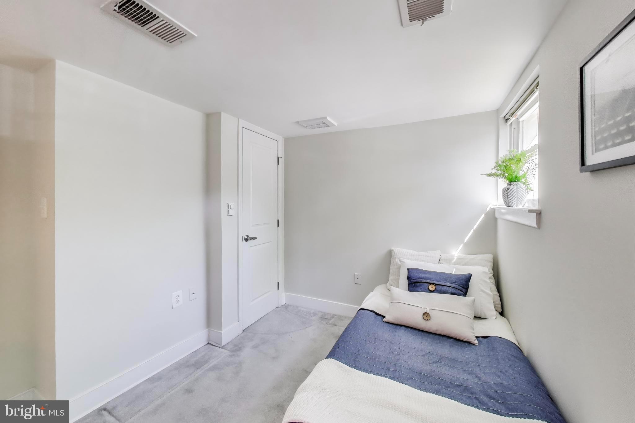 1106 Columbia Road Northwest, Unit 103 Washington, DC 20009 - Photo 15 of 21 a living room with furniture and rug