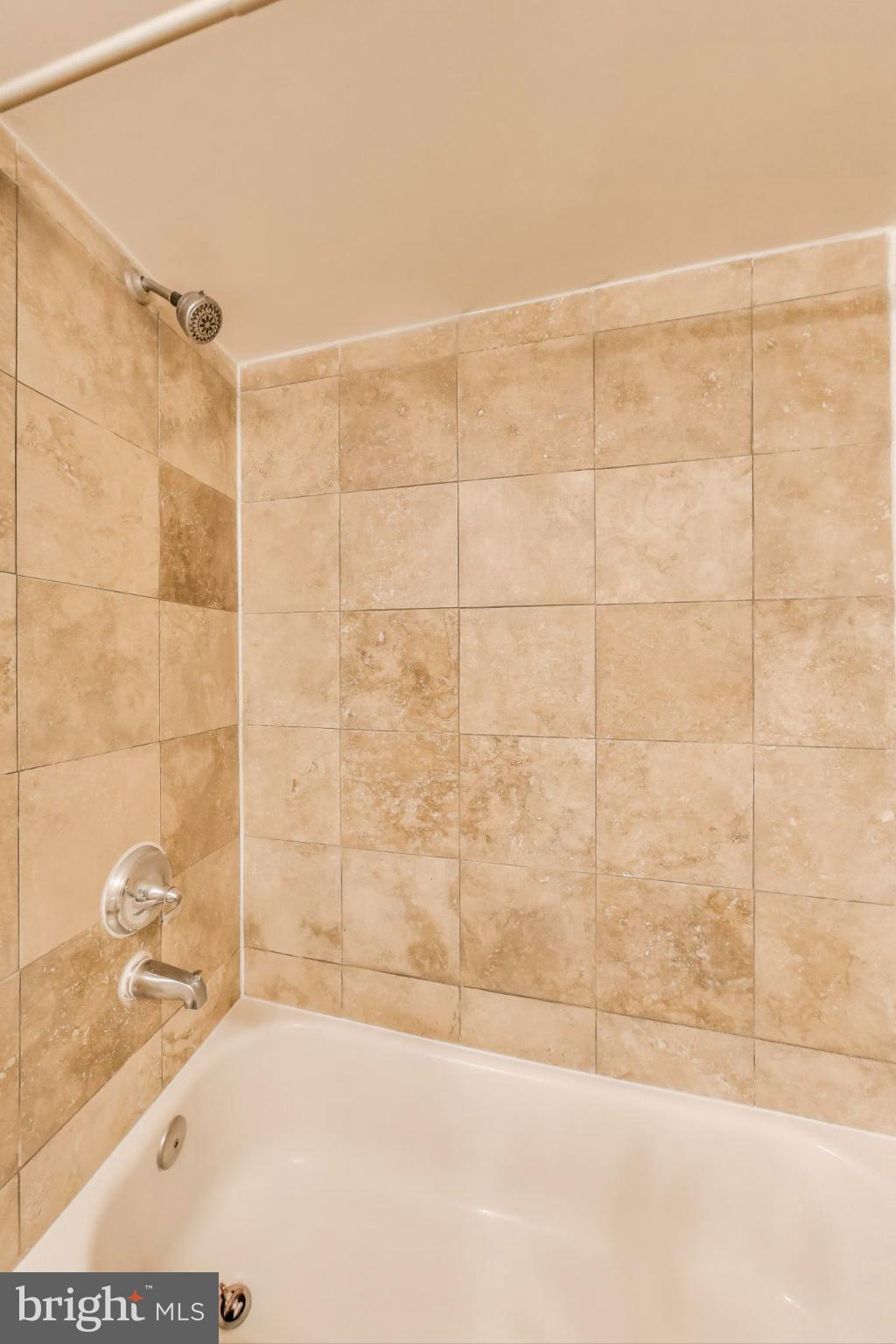 1106 Columbia Road Northwest, Unit 103 Washington, DC 20009 - Photo 18 of 21 a bathroom with a bathtub and shower