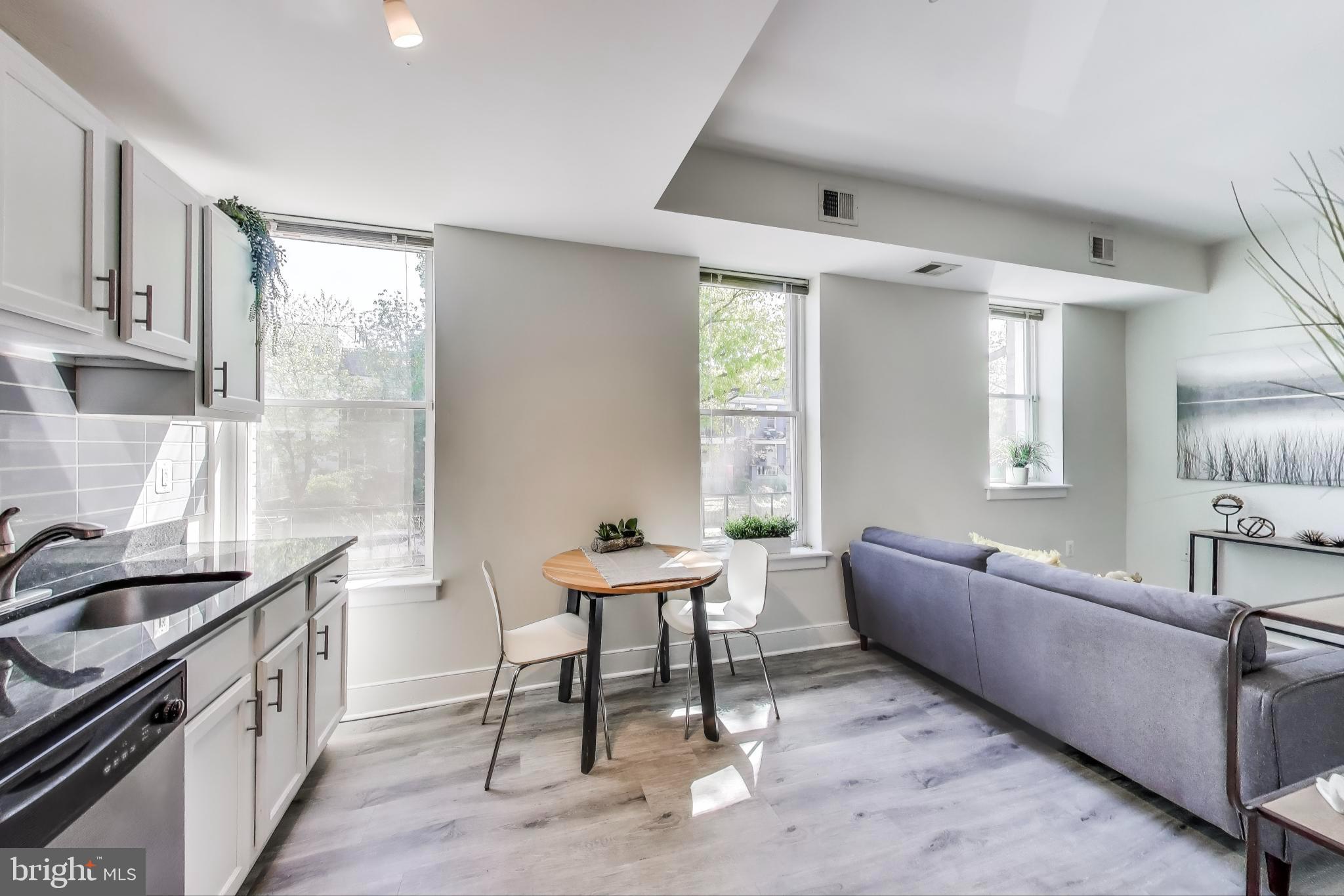 1106 Columbia Road Northwest, Unit 103 Washington, DC 20009 - Photo 9 of 21 a living room with furniture and a window