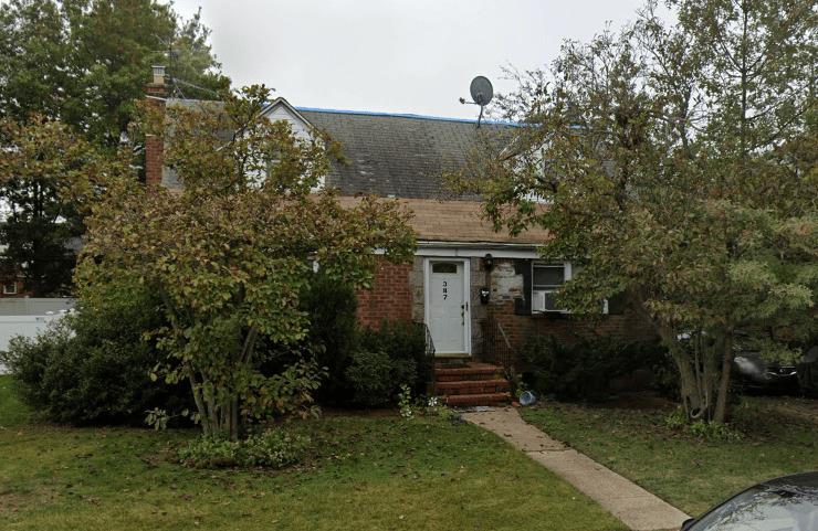 a view of a house with a yard and tree s