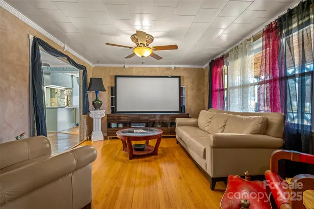 a living room with furniture and a chandelier