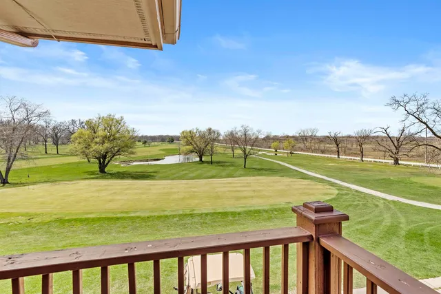 a view of a park with iron fence