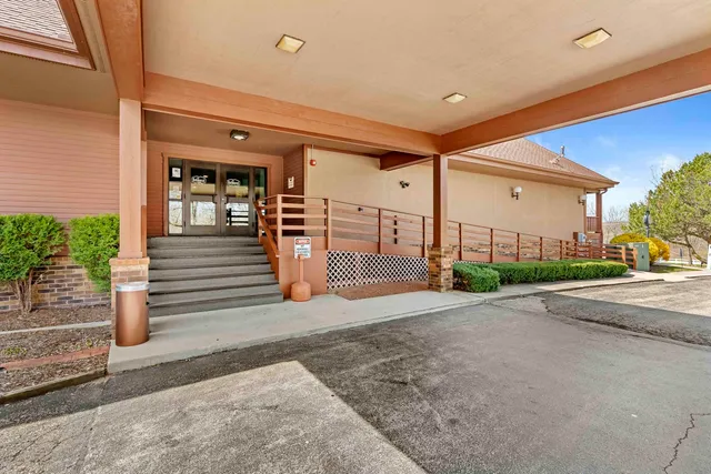 a view of a house with backyard and porch