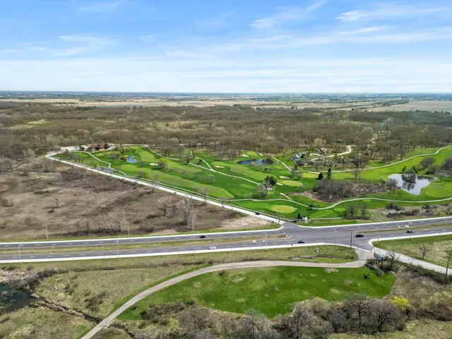 an aerial view of a house with swimming pool and garden