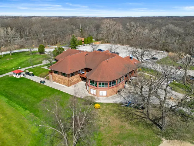 an aerial view of a house with garden space and lake view