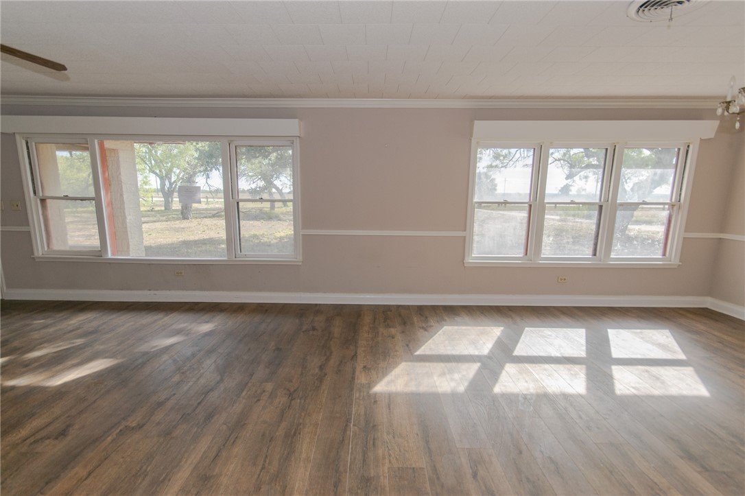 3867 Highway 59 George West, TX 78022 - Photo 13 of 40 a view of an empty room with wooden floor and a window