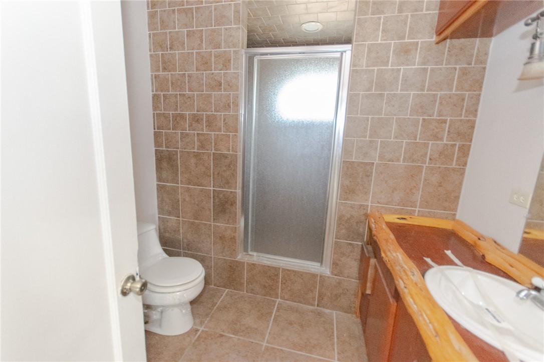 3867 Highway 59 George West, TX 78022 - Photo 17 of 40 a bathroom with a sink a toilet and shower