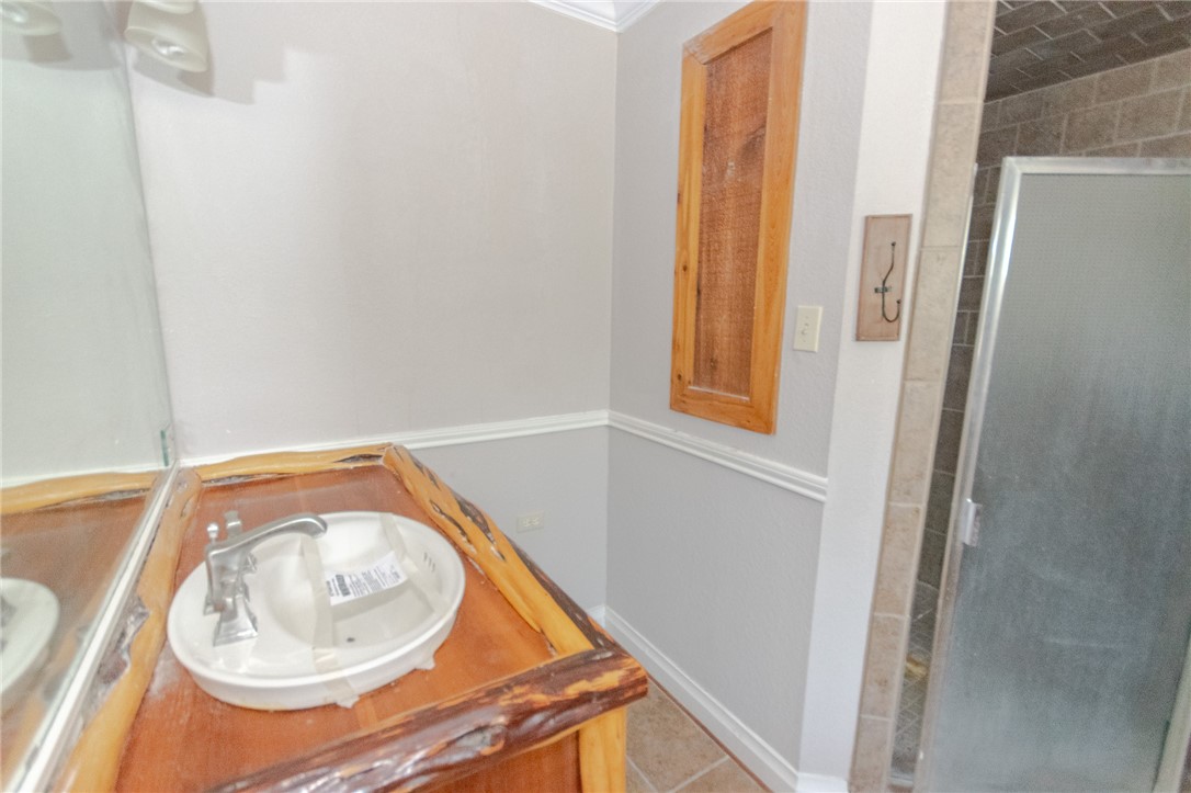 3867 Highway 59 George West, TX 78022 - Photo 18 of 40 a small bathroom with a sink and a mirror