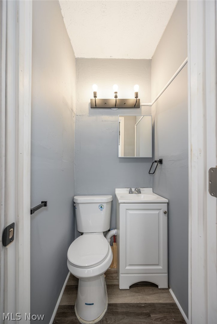 1603 Hampton Road Akron, OH 44305 - Photo 13 of 50 Half bathroom featuring vanity and dark wood-style flooring