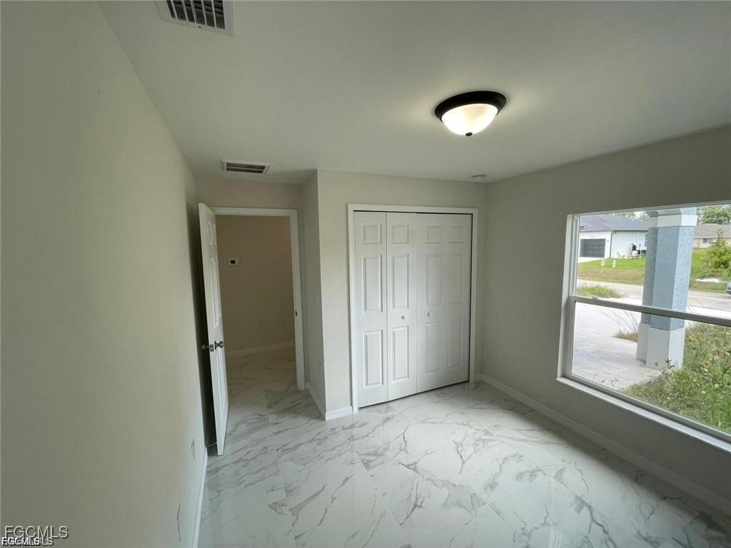 4657-4659 26th Street Southwest Lehigh Acres, FL 33973 - Photo 11 of 24 a view of an empty room with a window