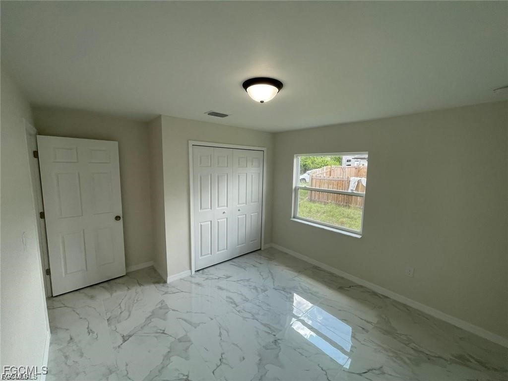4657-4659 26th Street Southwest Lehigh Acres, FL 33973 - Photo 12 of 24 a view of an empty room and window