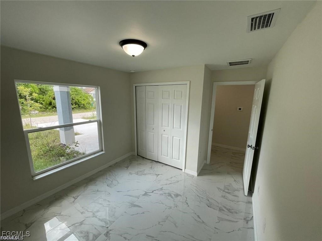 4657-4659 26th Street Southwest Lehigh Acres, FL 33973 - Photo 15 of 24 an empty room with windows