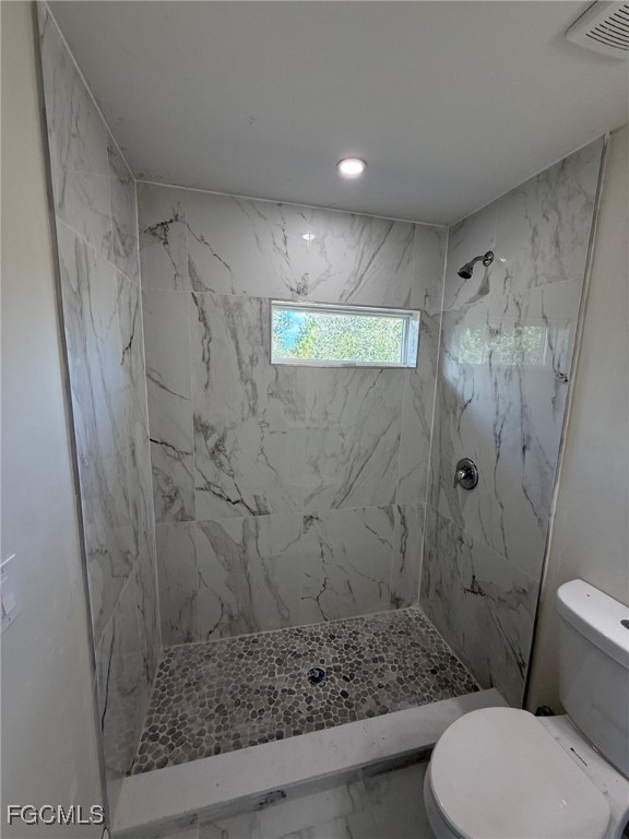 4657-4659 26th Street Southwest Lehigh Acres, FL 33973 - Photo 16 of 24 a bathroom with a toilet and shower