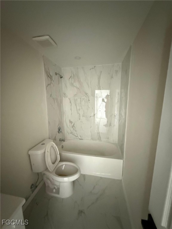 4657-4659 26th Street Southwest Lehigh Acres, FL 33973 - Photo 19 of 24 a bathroom with a granite countertop toilet and a shower